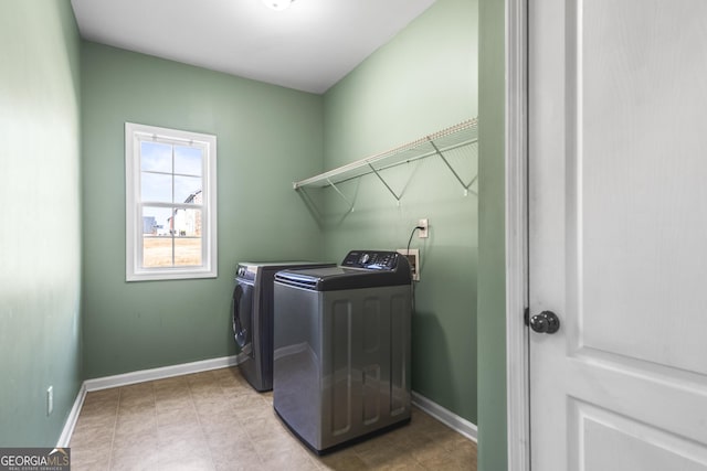 laundry room featuring laundry area, baseboards, and washer and dryer