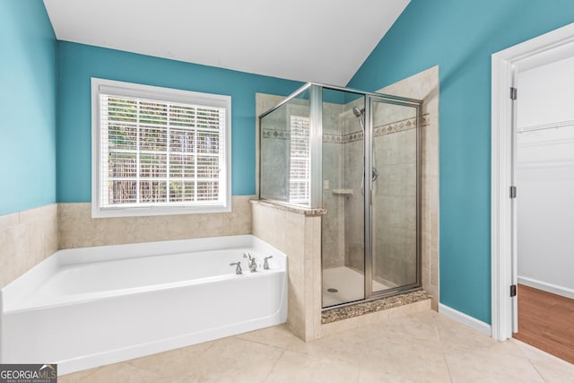 100 Windmeadow Way, Fayetteville, GA 30214 - bathroom with a shower stall, a bath, tile patterned floors, lofted ceiling, and a walk in closet