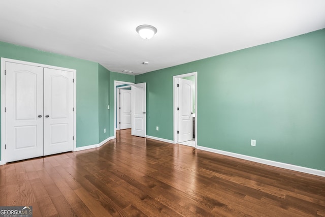 100 Windmeadow Way, Fayetteville, GA 30214 - unfurnished bedroom with baseboards, wood finished floors, and a closet