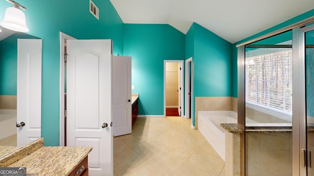 bathroom featuring visible vents, lofted ceiling, tile patterned floors, vanity, and a bath