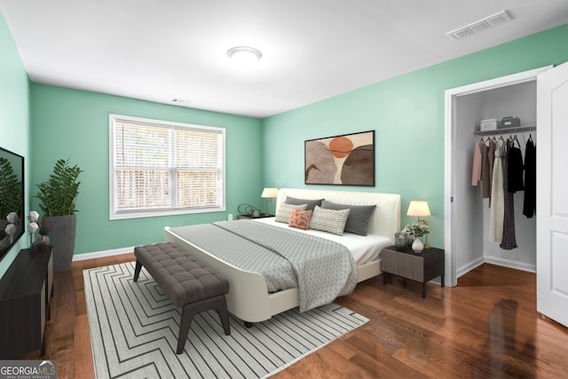 bedroom featuring baseboards, visible vents, wood finished floors, a walk in closet, and a closet