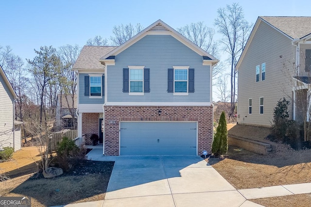 traditional-style home featuring a garage, brick siding, and driveway