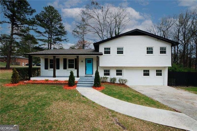 split level home featuring covered porch and a front lawn