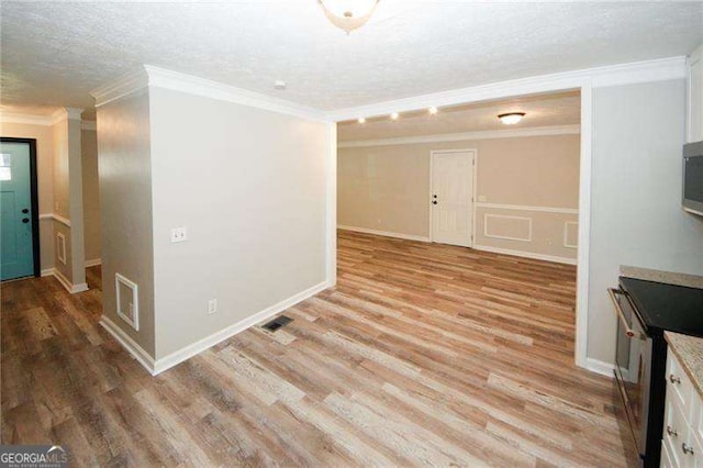 interior space featuring crown molding, a textured ceiling, and light wood-type flooring