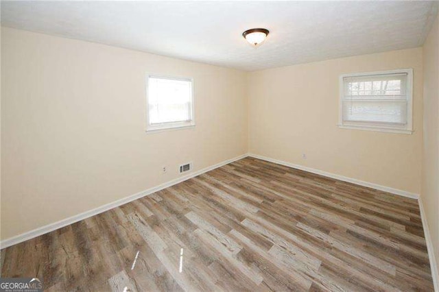 spare room featuring wood-type flooring