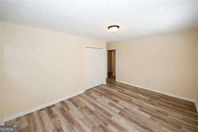 empty room with hardwood / wood-style flooring