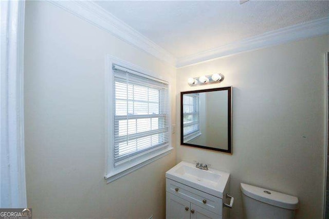 bathroom with crown molding, vanity, and toilet