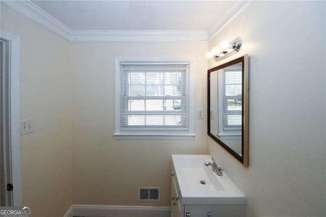 bathroom with vanity, a healthy amount of sunlight, and ornamental molding