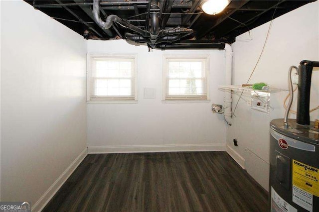 interior space featuring a healthy amount of sunlight, dark hardwood / wood-style flooring, and electric water heater