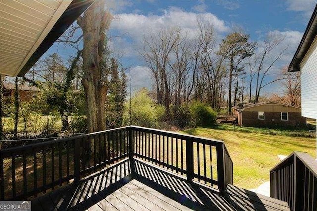 wooden terrace featuring a yard