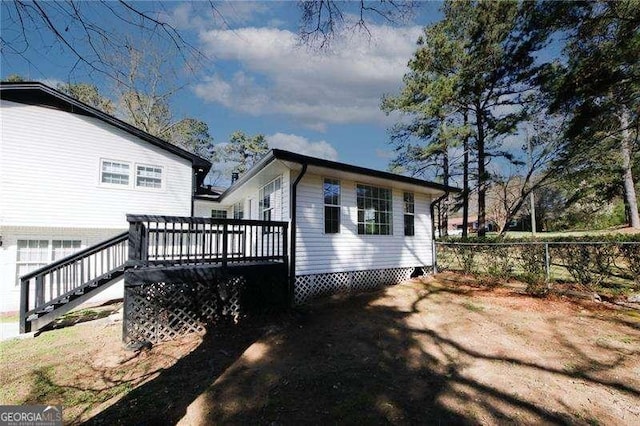 rear view of property with a wooden deck