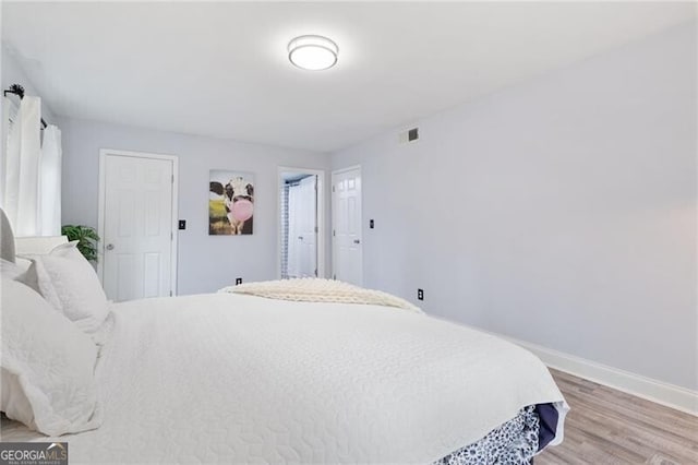 bedroom with wood-type flooring