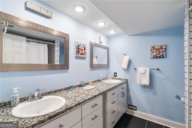 bathroom featuring tile patterned flooring and vanity