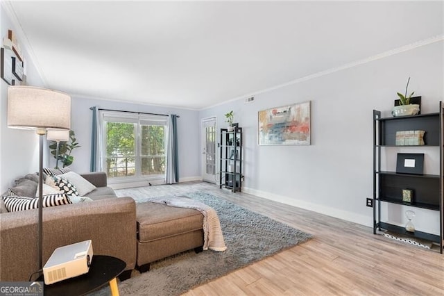 living room featuring hardwood / wood-style floors and ornamental molding