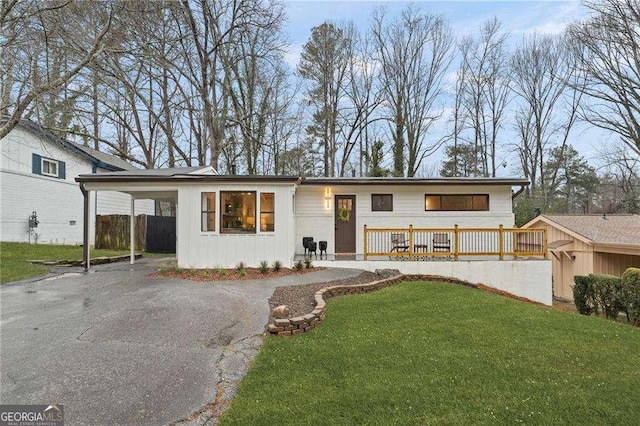 view of front facade with a front yard and a carport