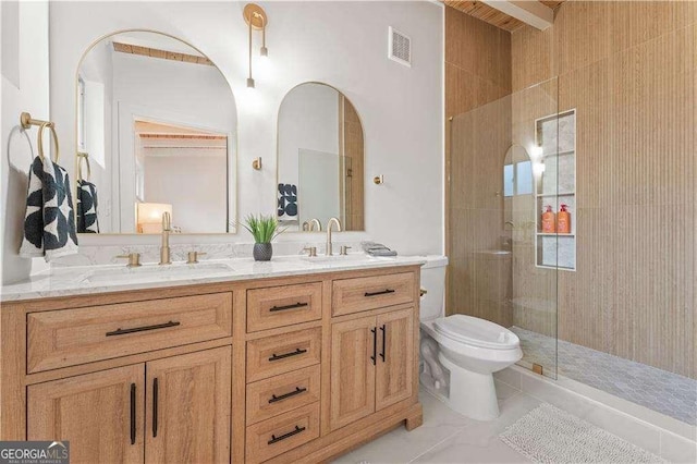 bathroom with vanity, toilet, and a shower with shower door