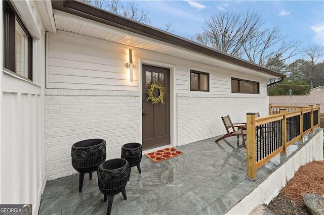 entrance to property featuring a patio