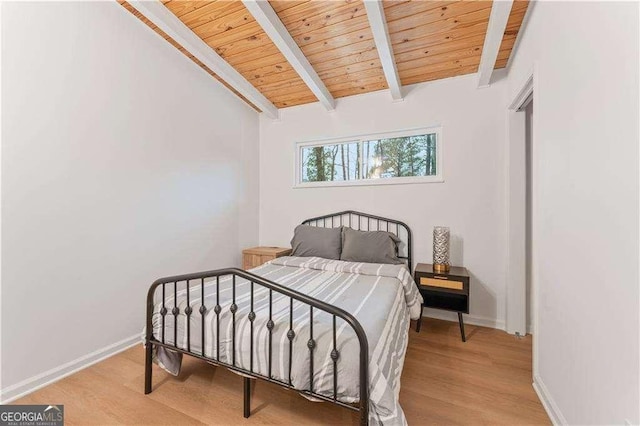 bedroom featuring wood ceiling, wood-type flooring, and vaulted ceiling with beams