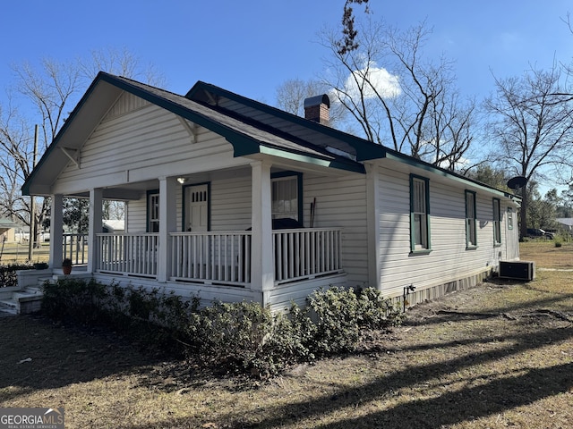 view of front facade with a porch and central AC unit