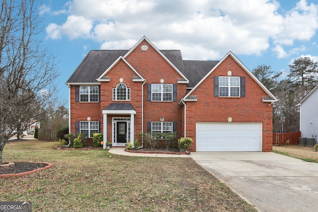 view of front of property featuring a garage, a front yard, and central air condition unit