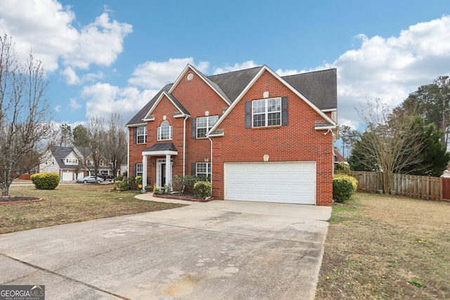 view of front property featuring a garage and a front yard