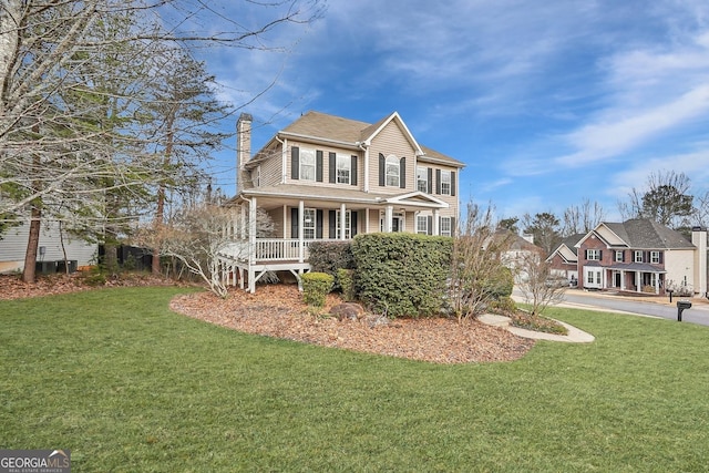 view of front of home featuring a front yard and covered porch