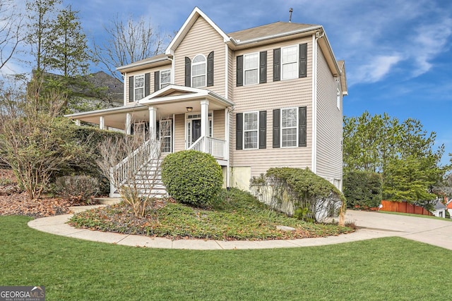 view of front of home with a porch and a front yard