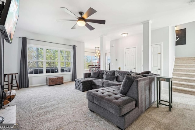 living room with light carpet, a fireplace, and ceiling fan