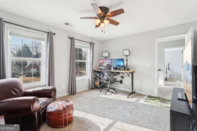 office area featuring light carpet and ceiling fan