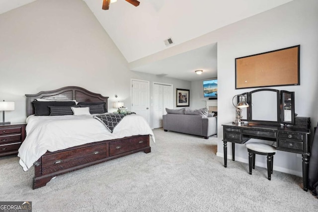 carpeted bedroom featuring ceiling fan and high vaulted ceiling