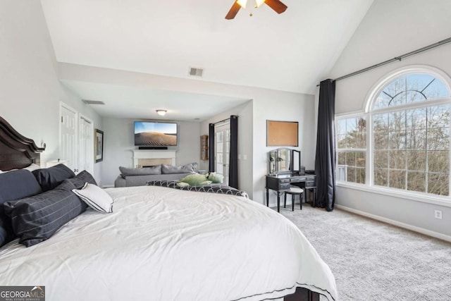 bedroom with ensuite bath, high vaulted ceiling, ceiling fan, and carpet flooring