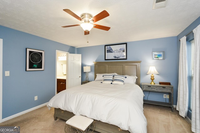 bedroom featuring light carpet, a textured ceiling, visible vents, and baseboards