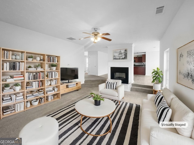 carpeted living room with ceiling fan