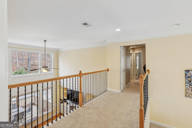 corridor featuring crown molding and light colored carpet