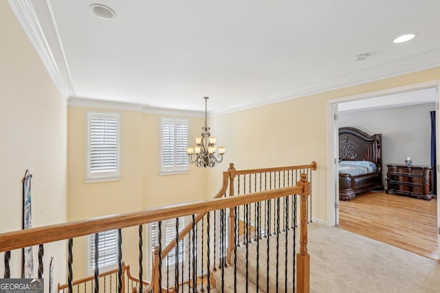 corridor with crown molding, light carpet, and a notable chandelier