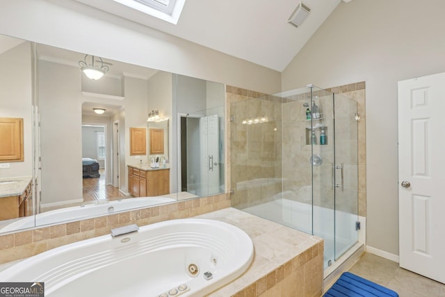 bathroom featuring separate shower and tub, high vaulted ceiling, a skylight, vanity, and tile patterned flooring