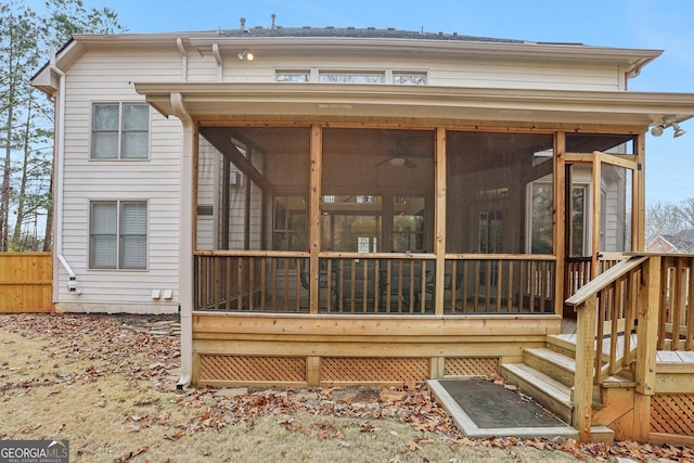 rear view of property featuring a sunroom