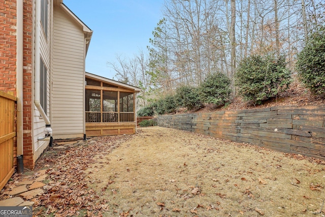 view of yard featuring a sunroom