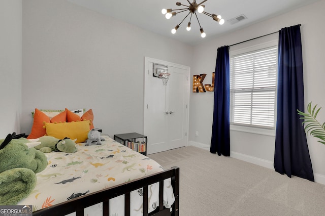 bedroom with light carpet and an inviting chandelier