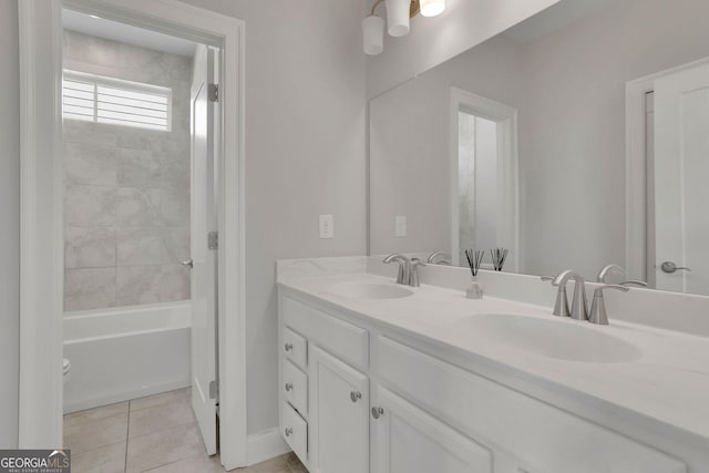 bathroom with tile patterned floors, vanity, and tiled shower / bath