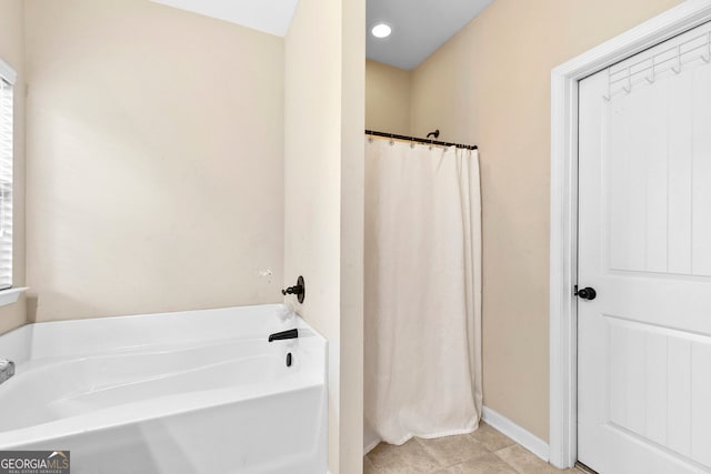 bathroom featuring tile patterned flooring and a tub