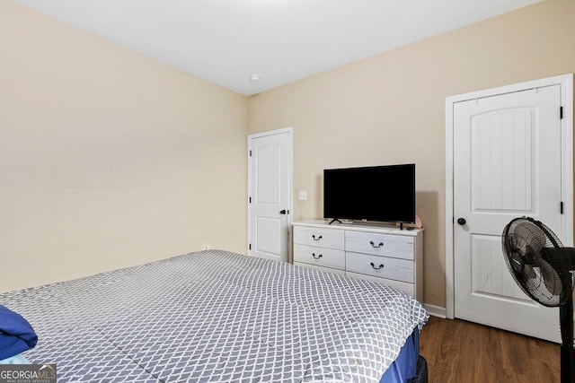 bedroom with dark hardwood / wood-style flooring