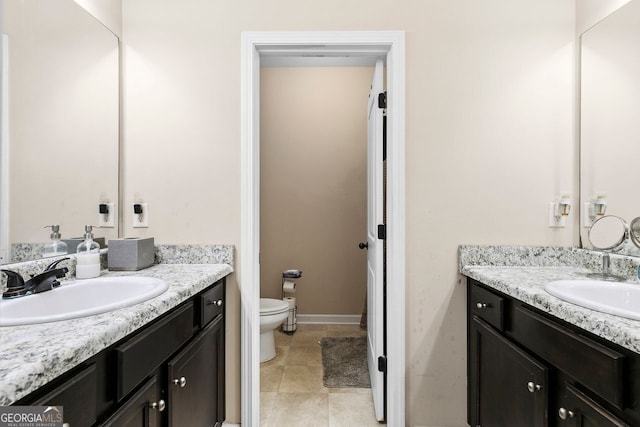 bathroom featuring tile patterned floors, vanity, and toilet