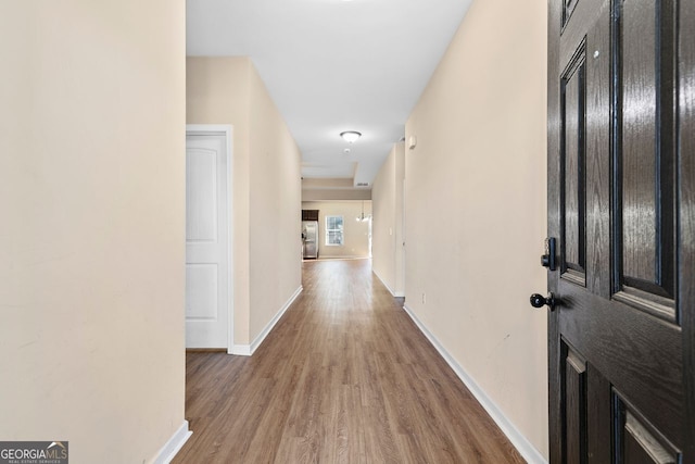 hall with hardwood / wood-style flooring