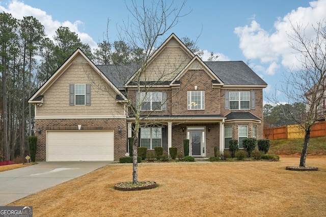 craftsman-style house featuring a garage and a front lawn