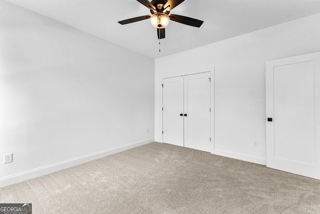 unfurnished bedroom featuring ceiling fan, carpet floors, and a closet