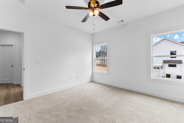 spare room featuring carpet floors and ceiling fan