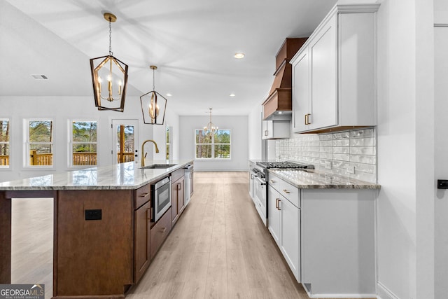 kitchen featuring hanging light fixtures, white cabinetry, and appliances with stainless steel finishes