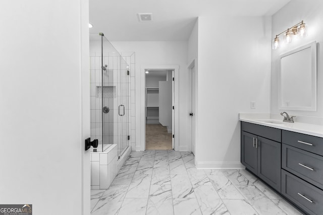 bathroom with vanity and a shower with shower door