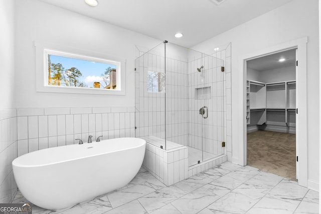 bathroom with independent shower and bath and tile walls